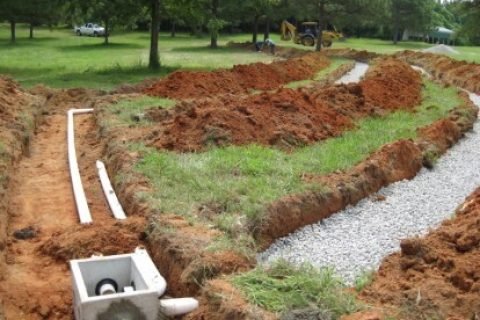 Septic drain field installation with distribution box and gravel lines